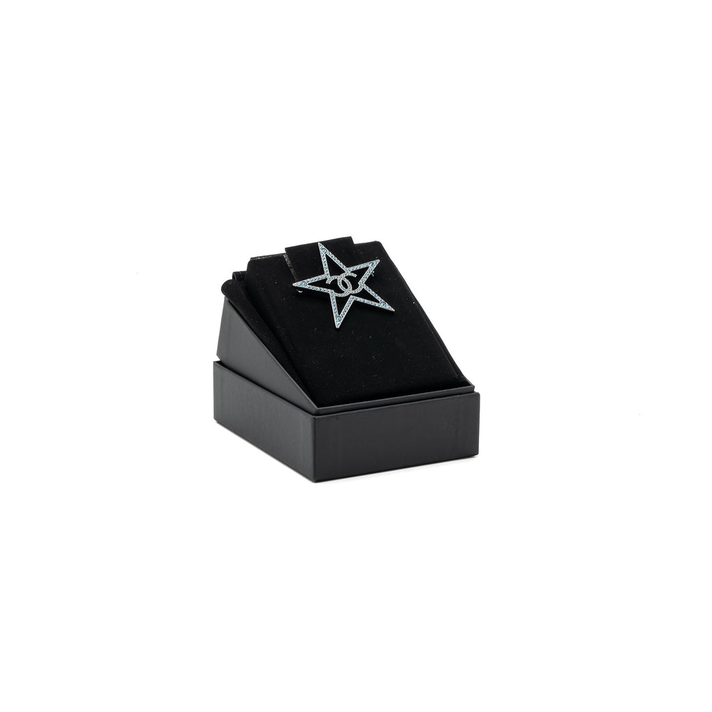 CHANEL STAR CC LOGO BROOCH CRYSTAL LIGHT BLUE WITH RUTHENIUM HARDWARE
