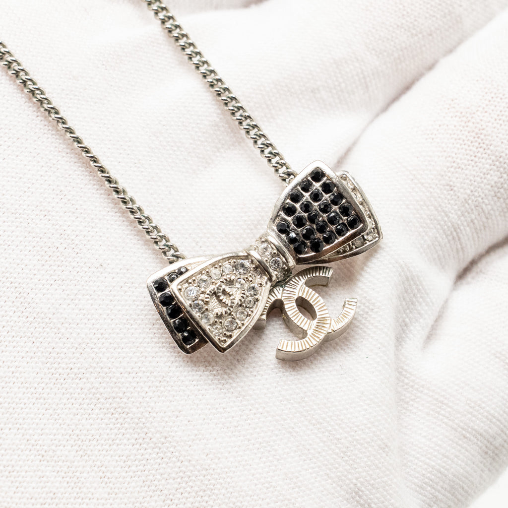 CHANEL BOW/CC LOGO DROP NECKLACE WITH CRYSTAL SILVER TONE