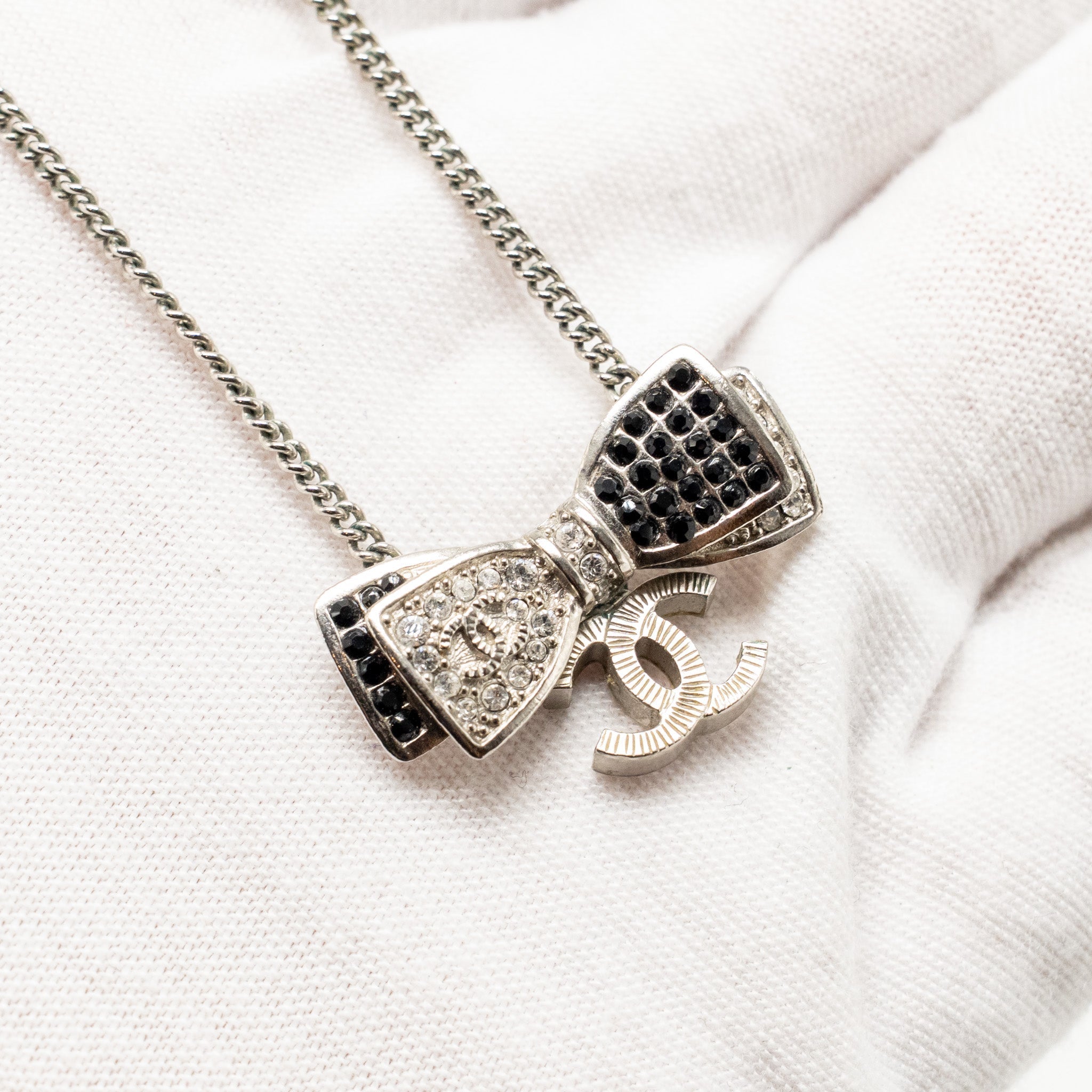 CHANEL BOW/CC LOGO DROP NECKLACE WITH CRYSTAL SILVER TONE