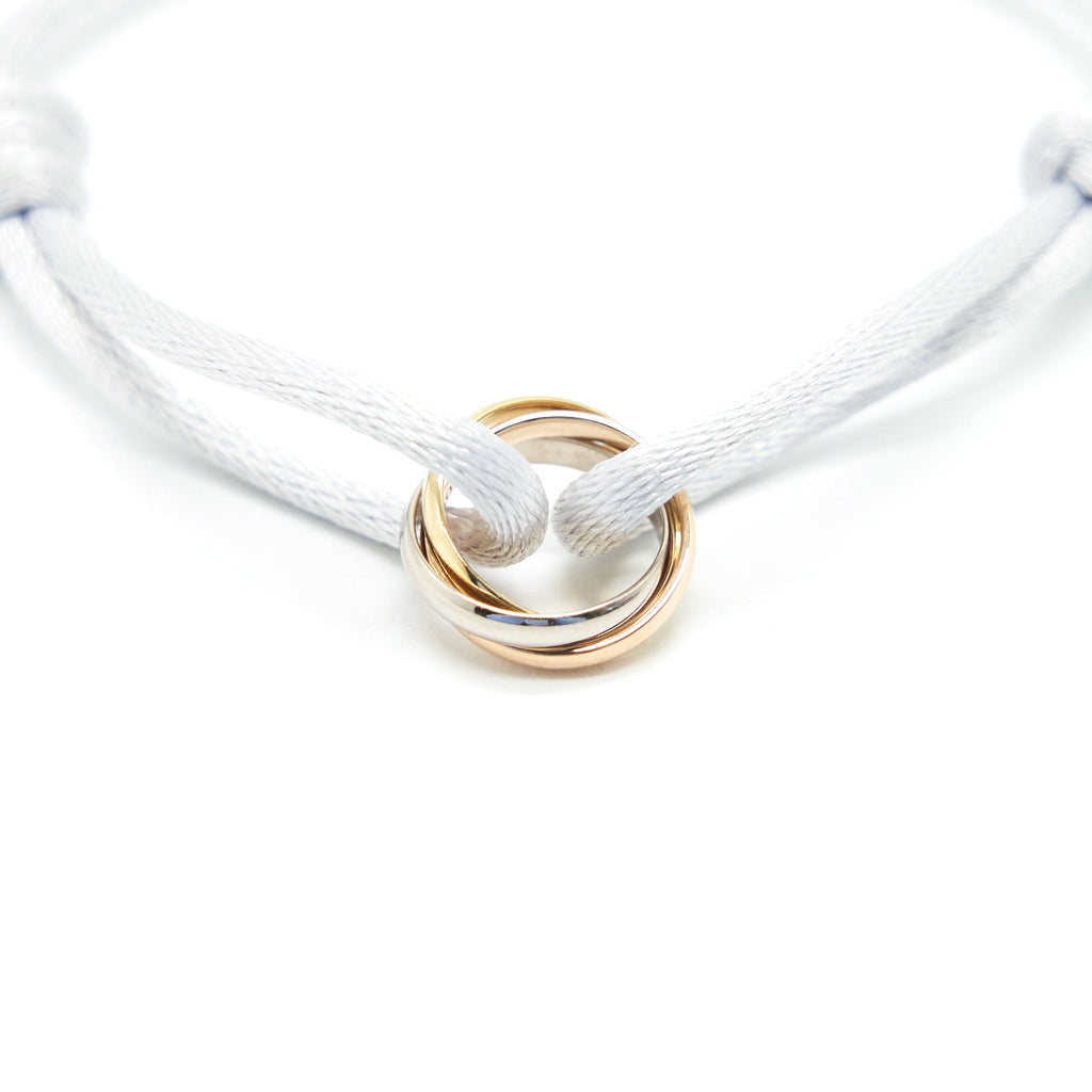 CARTIER TRINITY BRACELET, 3 GOLDS ON CORD