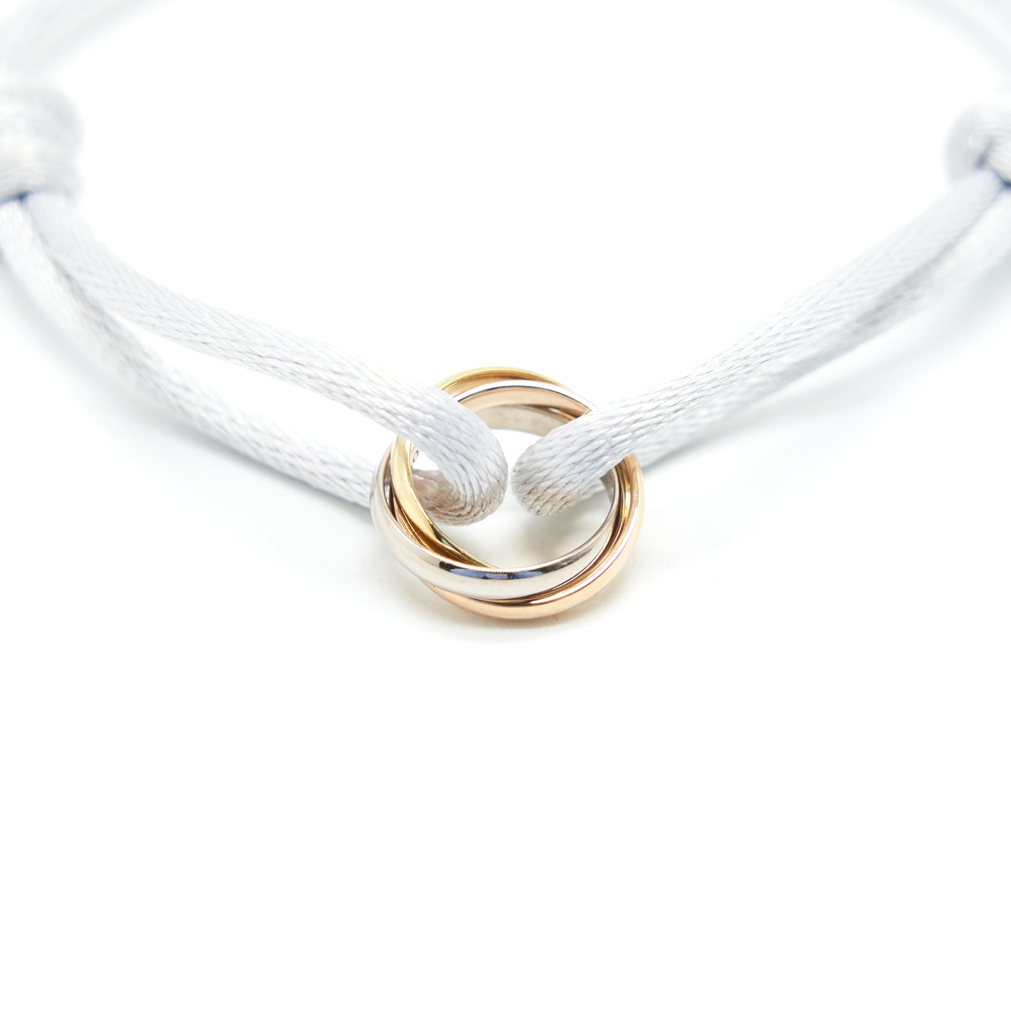 CARTIER TRINITY BRACELET, 3 GOLDS ON CORD